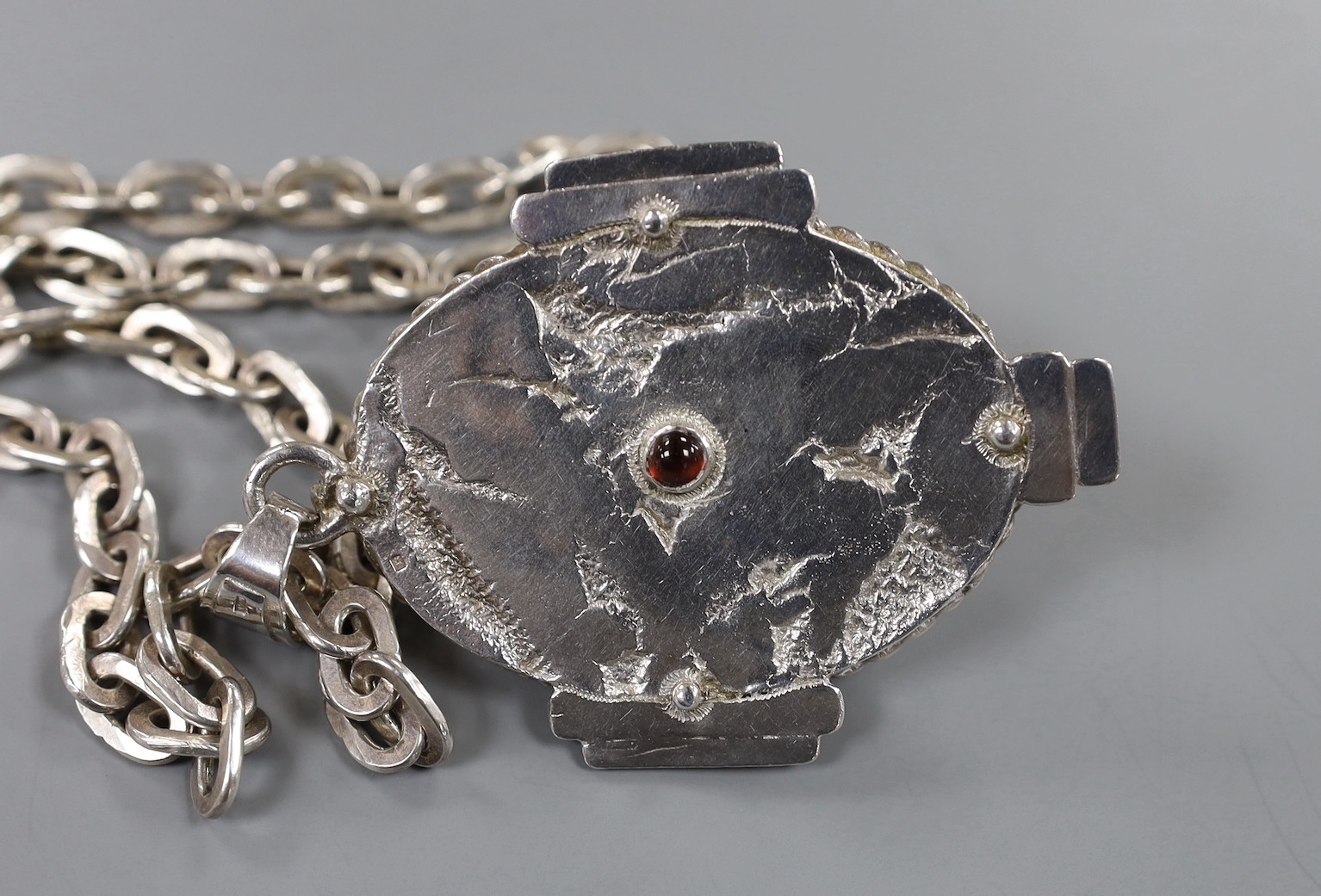 A modern silver and cabochon gem set pendant, on an oval link chain, by Michael Allen Bolton, London, 1992, pendant overall 93mm, chain, 46cm, gross weight 176 grams.